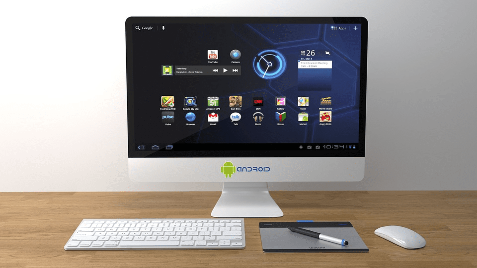 Android PC with a keyboard and mouse on a table displaying multiple apps on the screen.
