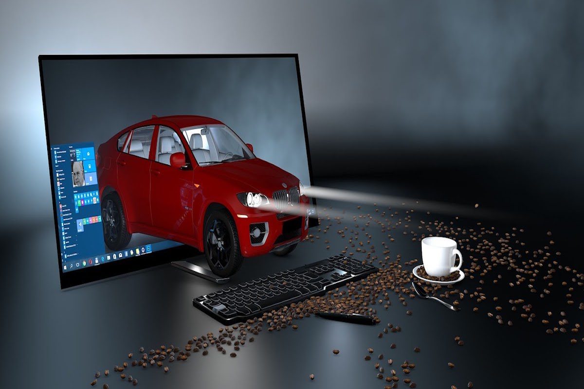 An animated image of a car emerging from a desktop computer.