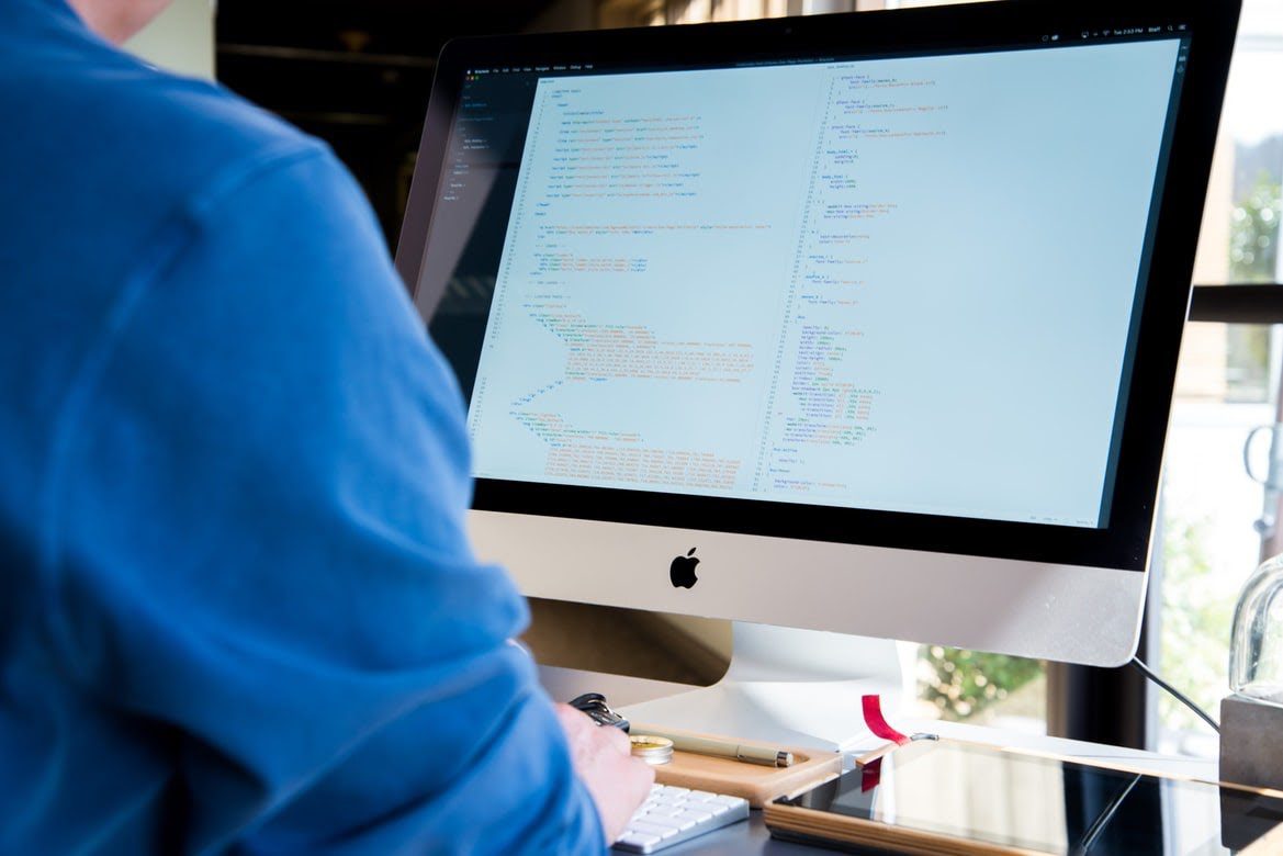 Man viewing code on a desktop. 