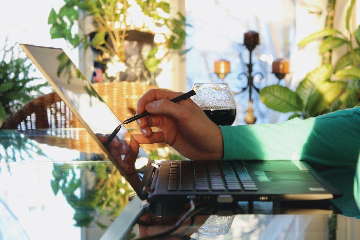 A man writing on a computer screen