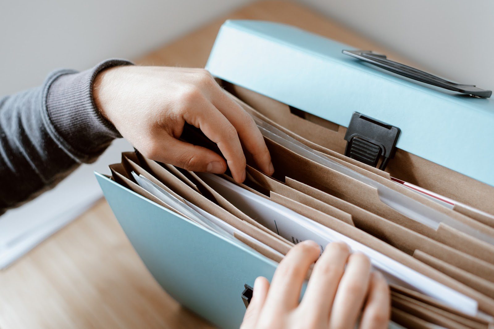 A person going through organized files.