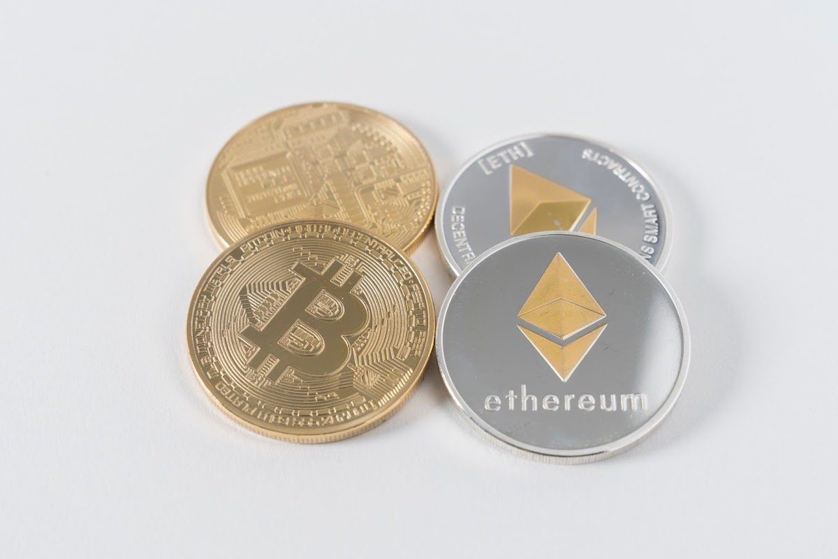 two Bitcoins and two Ethereum coins on a flat surface Online Blockchain Courses