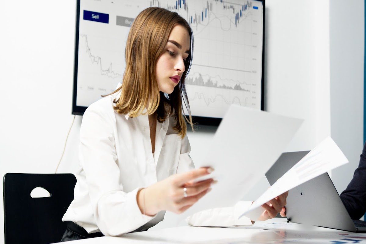 A woman holding papers while sitting in an office