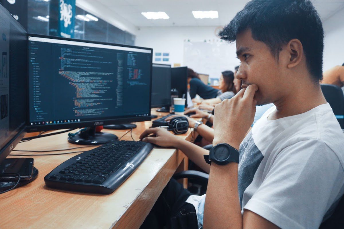 A man working on a code on a computer