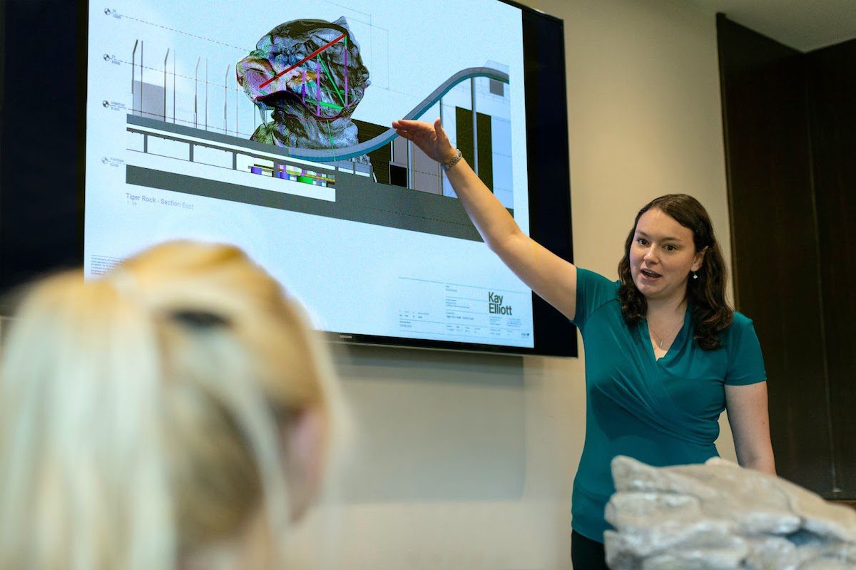 woman presenting slides of engineering designs