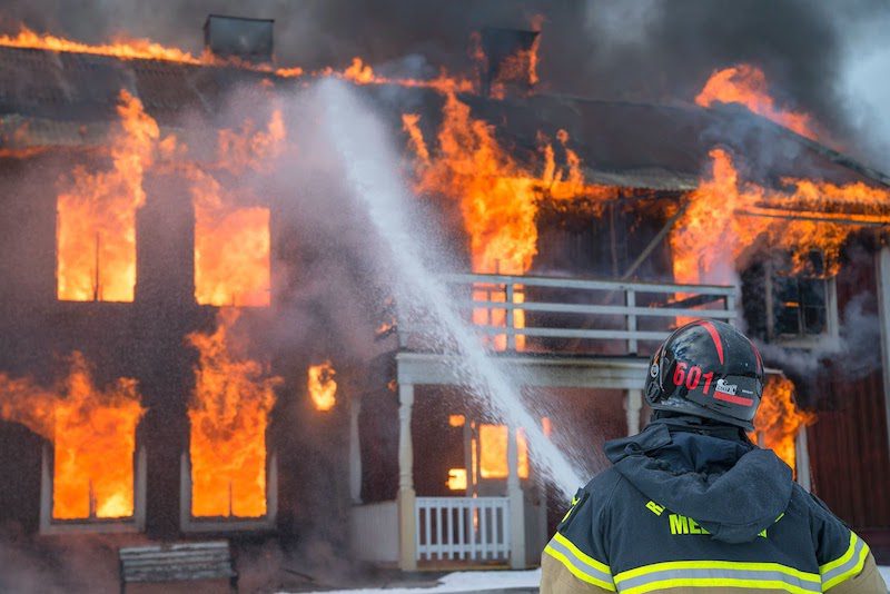 A firefighter putting put out a fire.