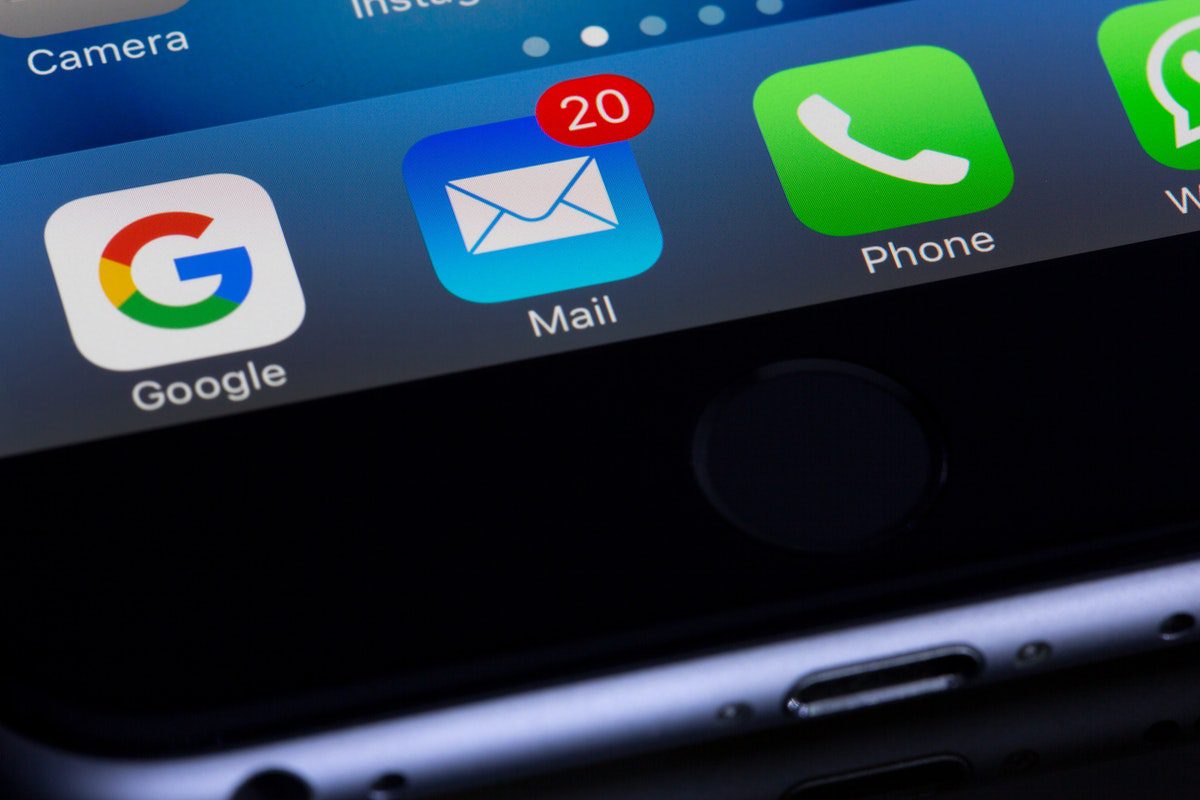 smartphone screen with an email icon that shows 20 unread emails. How to Become an Email Marketer
