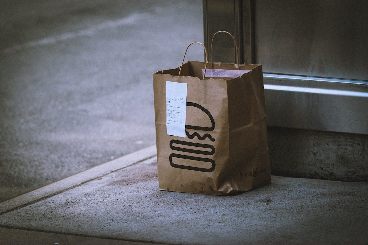 Paper bag sitting on the sidewalk for delivery. How Much Can You Make on Uber Eats?