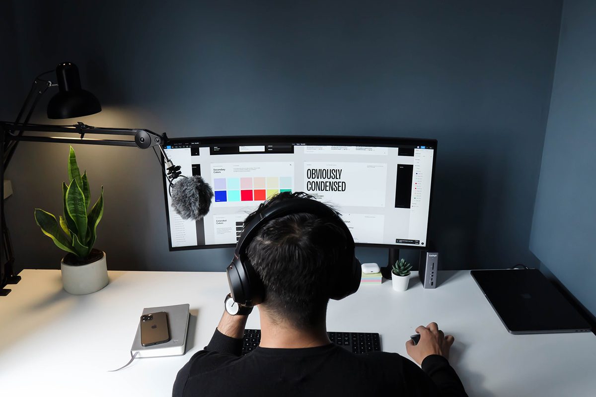A man making designs on a computer. UX Designer Job Satisfaction
