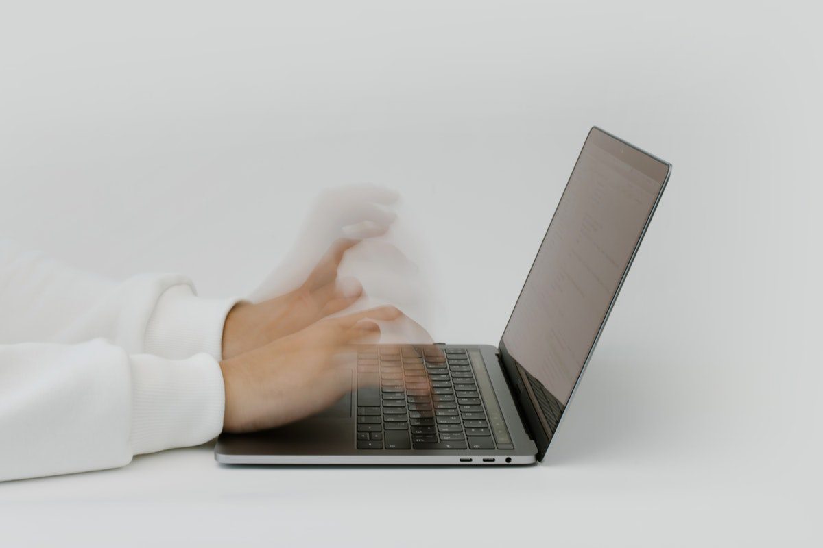 Close-up shot of someone typing a resume on their laptop. Technical Writer Cover Letter