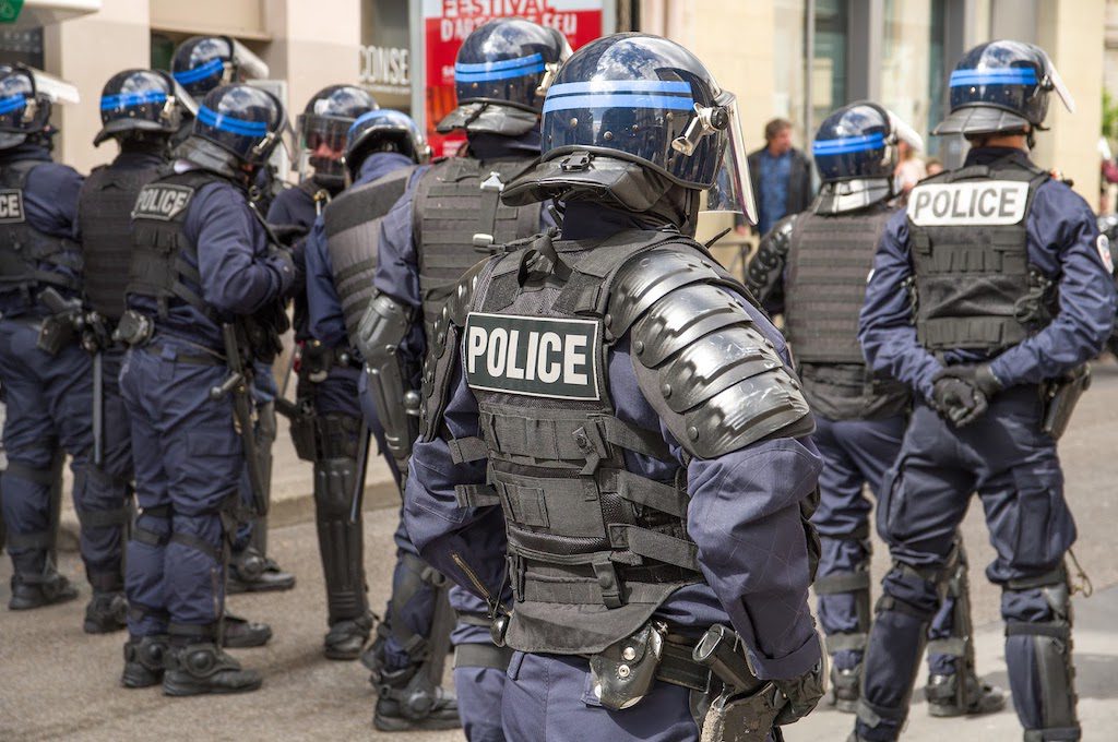 a group of police officers in riot gear