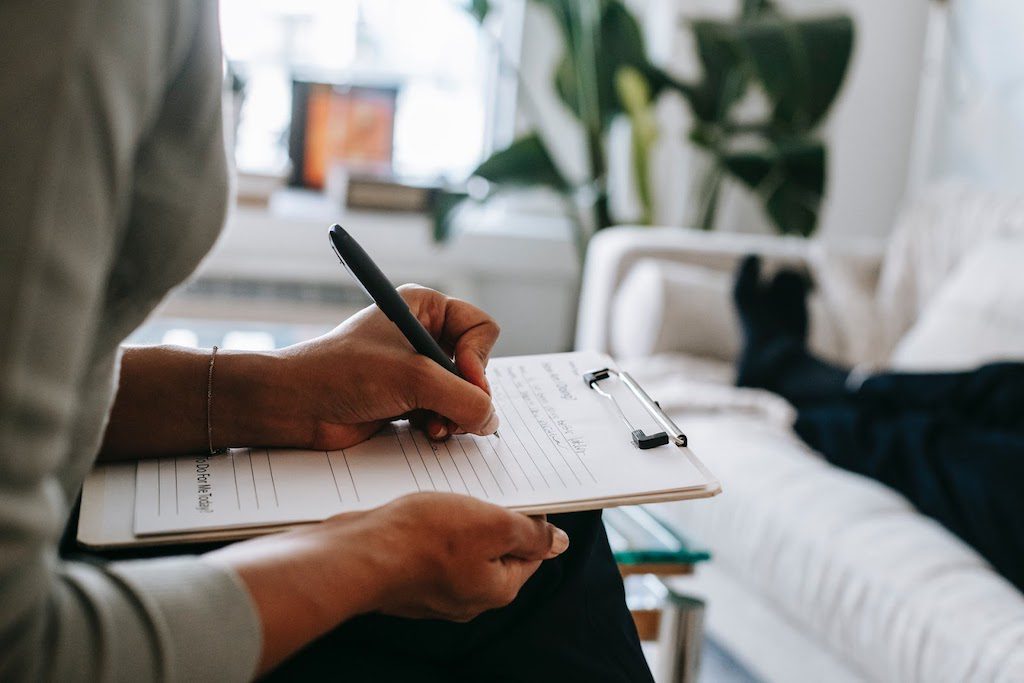 A psychologist taking notes during a session.