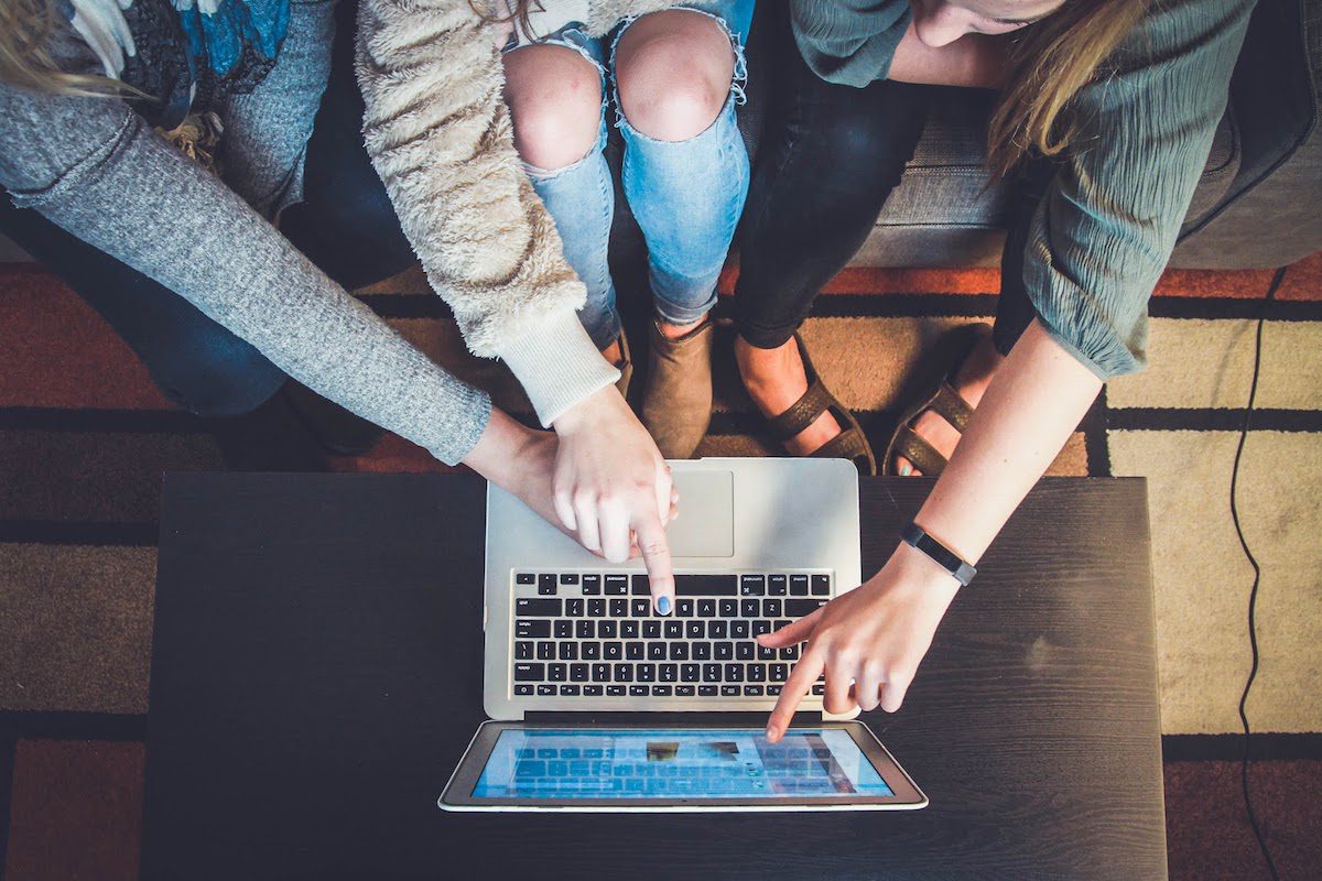 Three people selecting items on their laptop screen.