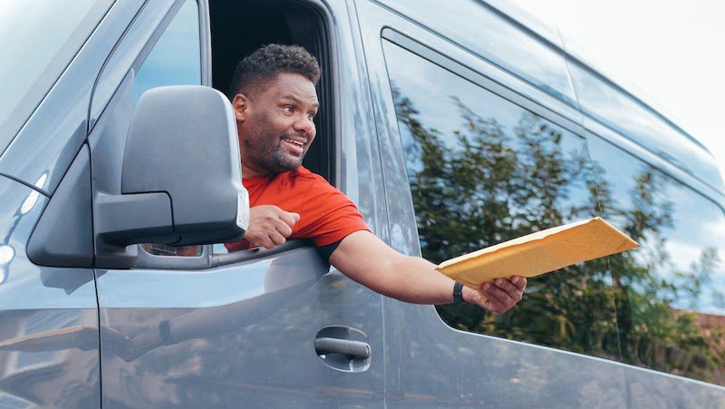 A man delivering a package in a van.