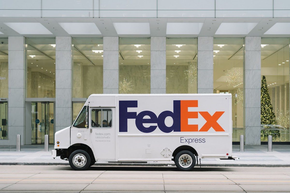 A FedEx light-duty truck parked in front of a commercial building. The Best Transportation Companies in 2022