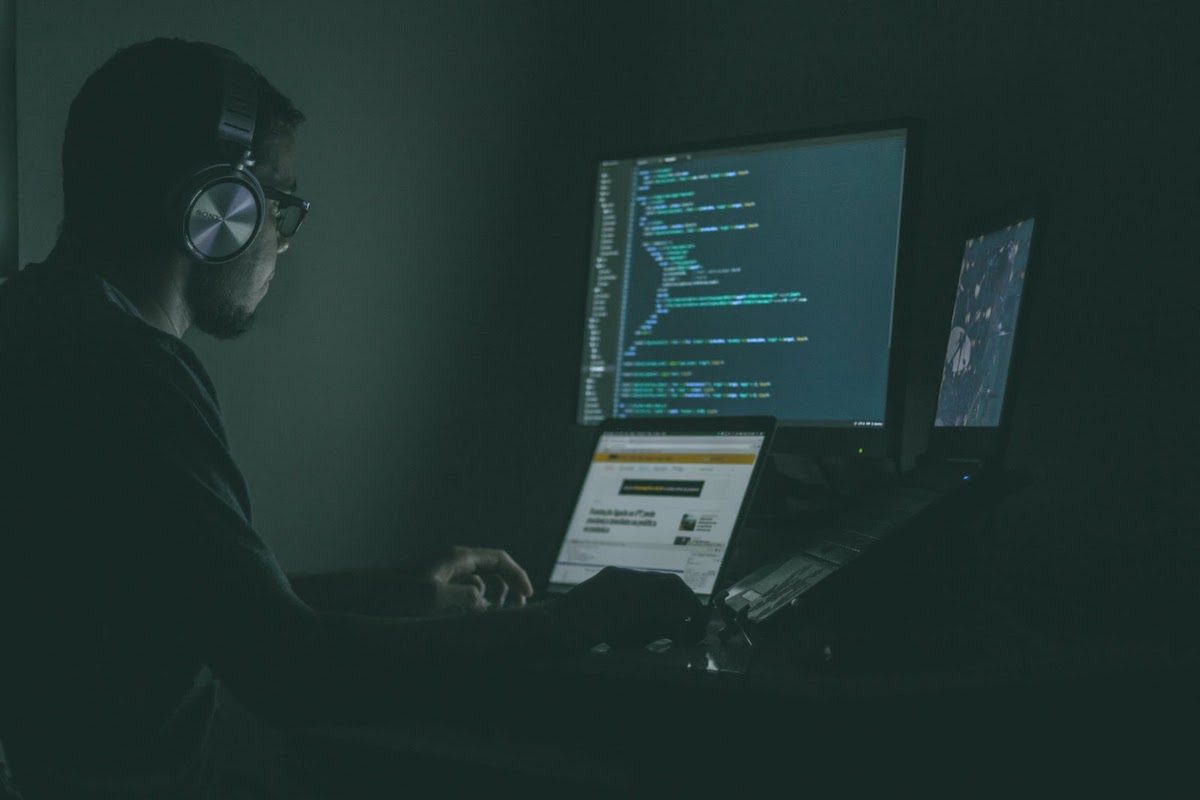 A computer programmer coding in the dark.