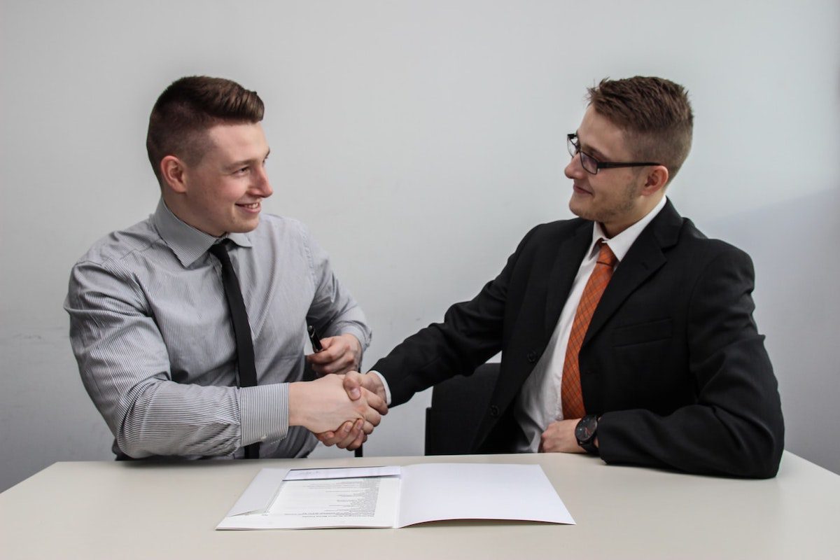 New employee shaking hands with the hiring manager after getting hired. Data Engineer Cover Letter