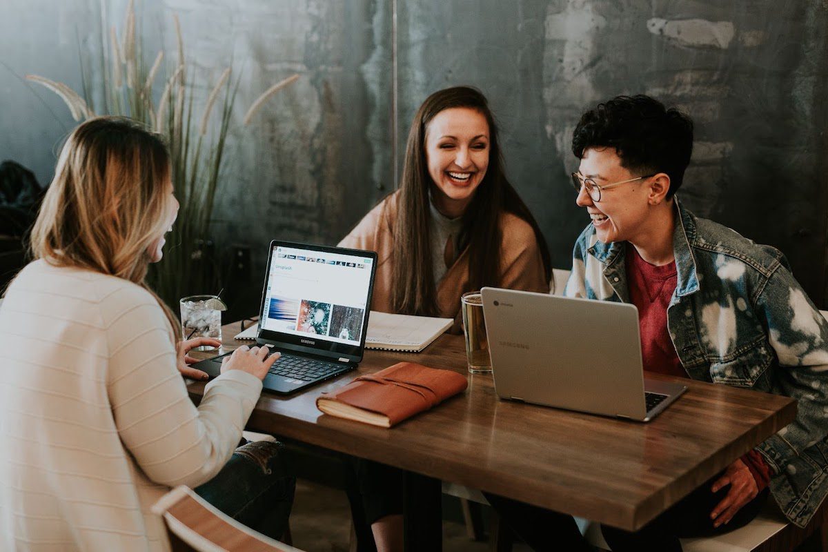 marketing interns laughing while working on a campaign