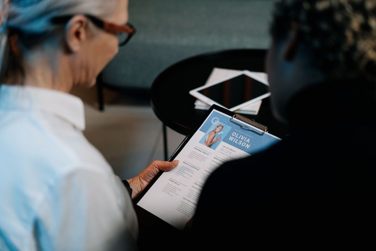  A recruiter going through a sample resume, attached to a clipboard. Senior Software Engineer Cover Letter