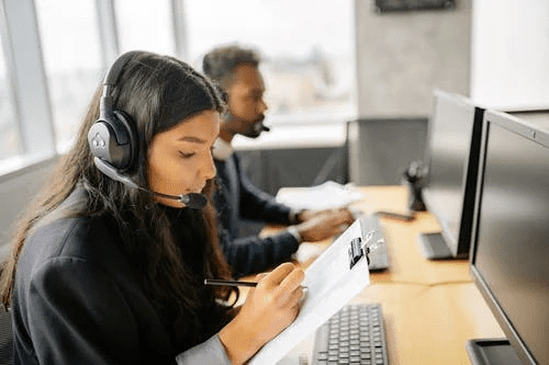 A team of call center employees working together in an office.