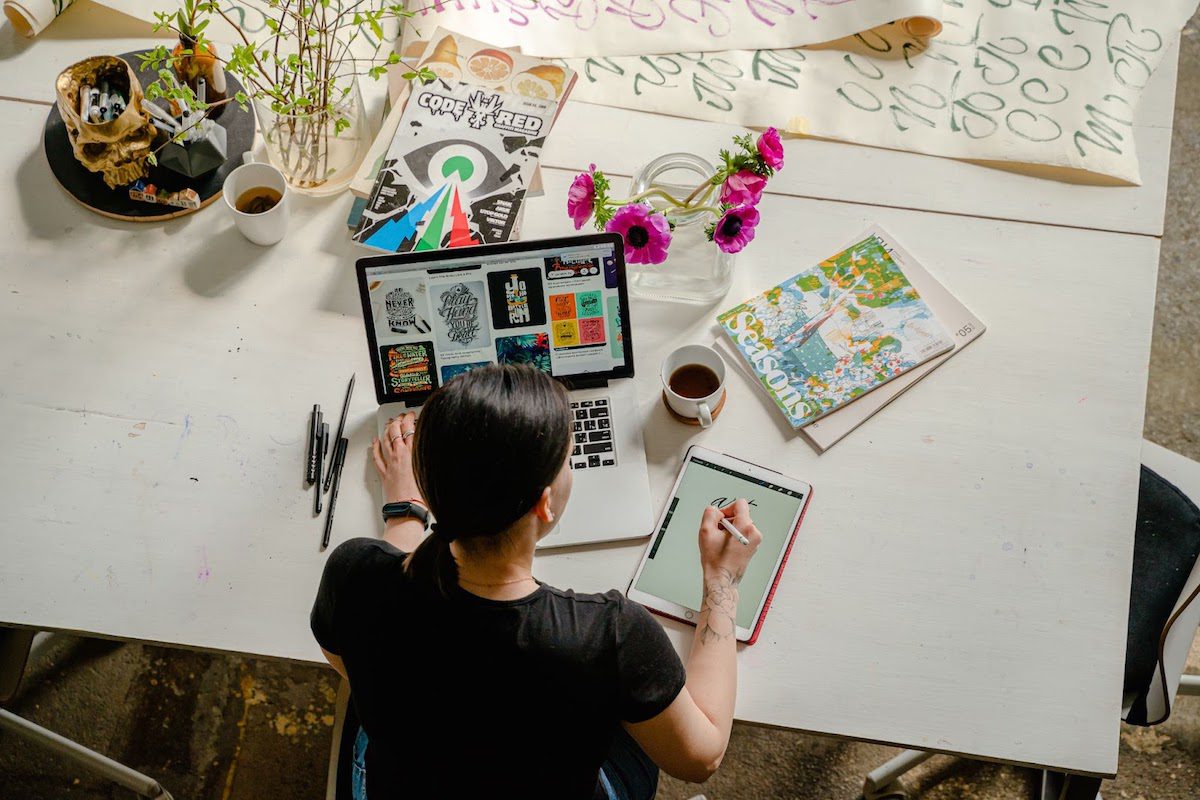 An overhead view of a freelancer completing a job for a client.