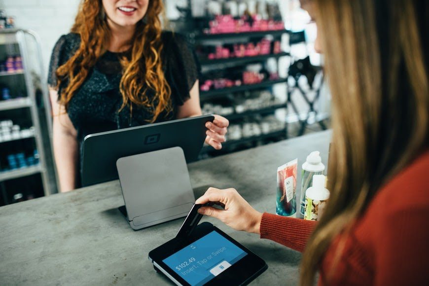 A customer paying for her purchase at a retail store