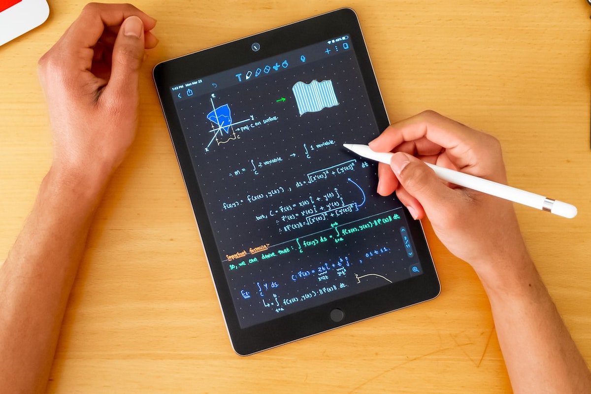 Bird’s eye view of a person writing equations on an iPad Jobs That Use Equations
