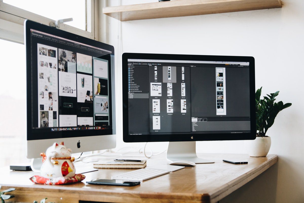 Two desktop computers showing web design software. Web Design Remote Jobs