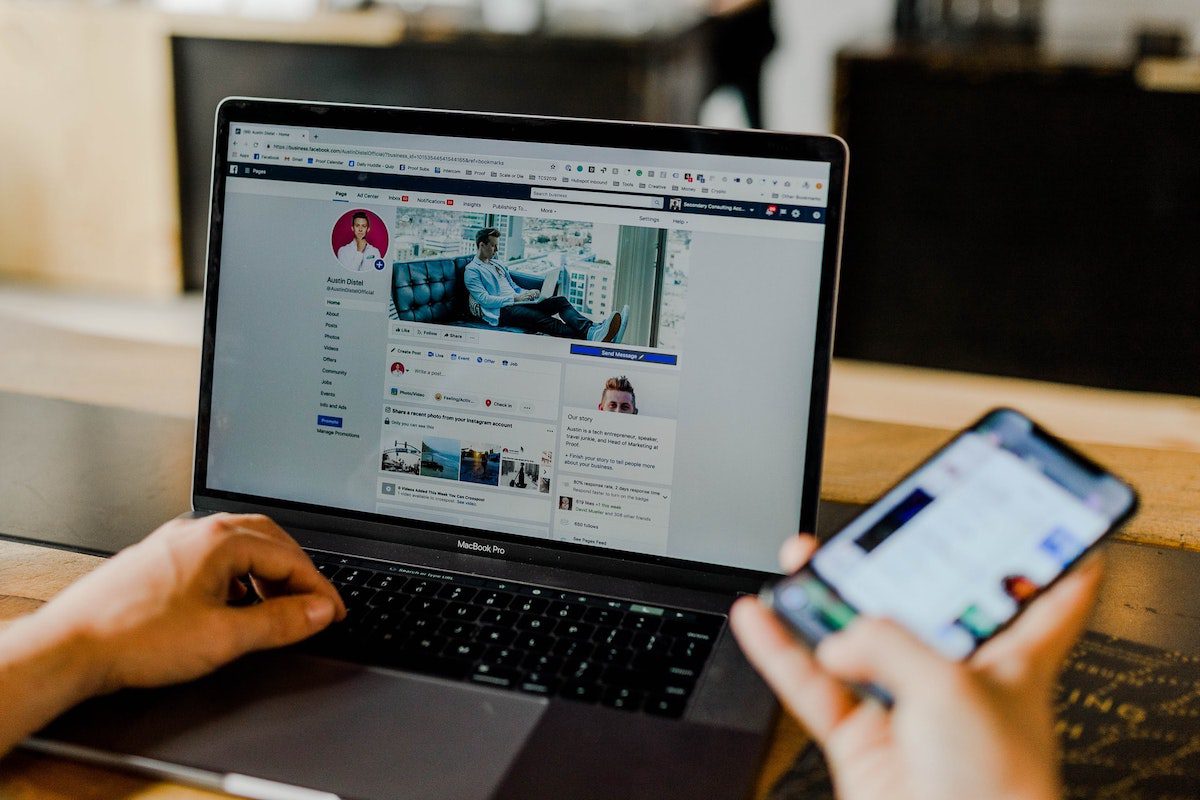 A social media marketer looking at their Facebook account using a Macbook Pro. Best Social Media Blogs