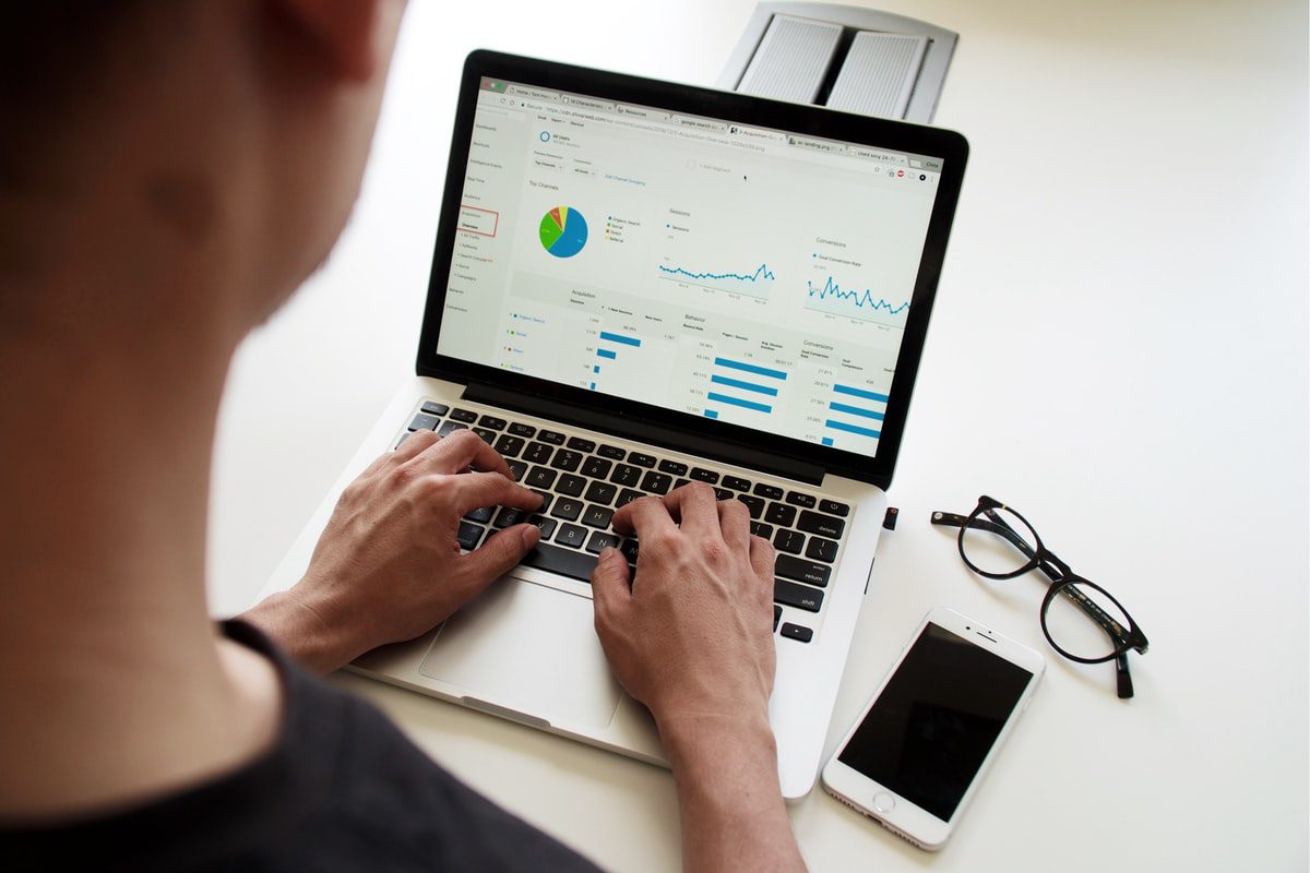 A data scientist using a laptop to curate their portfolio.