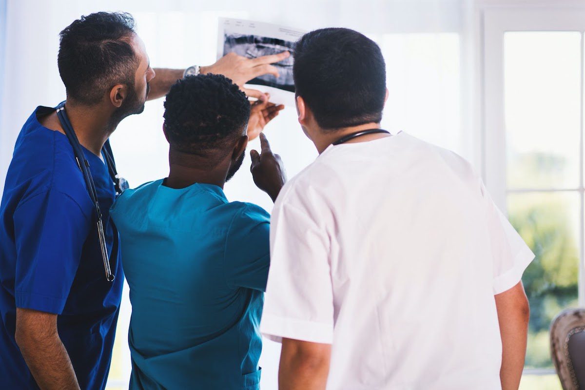 Healthcare professionals examine an x-ray