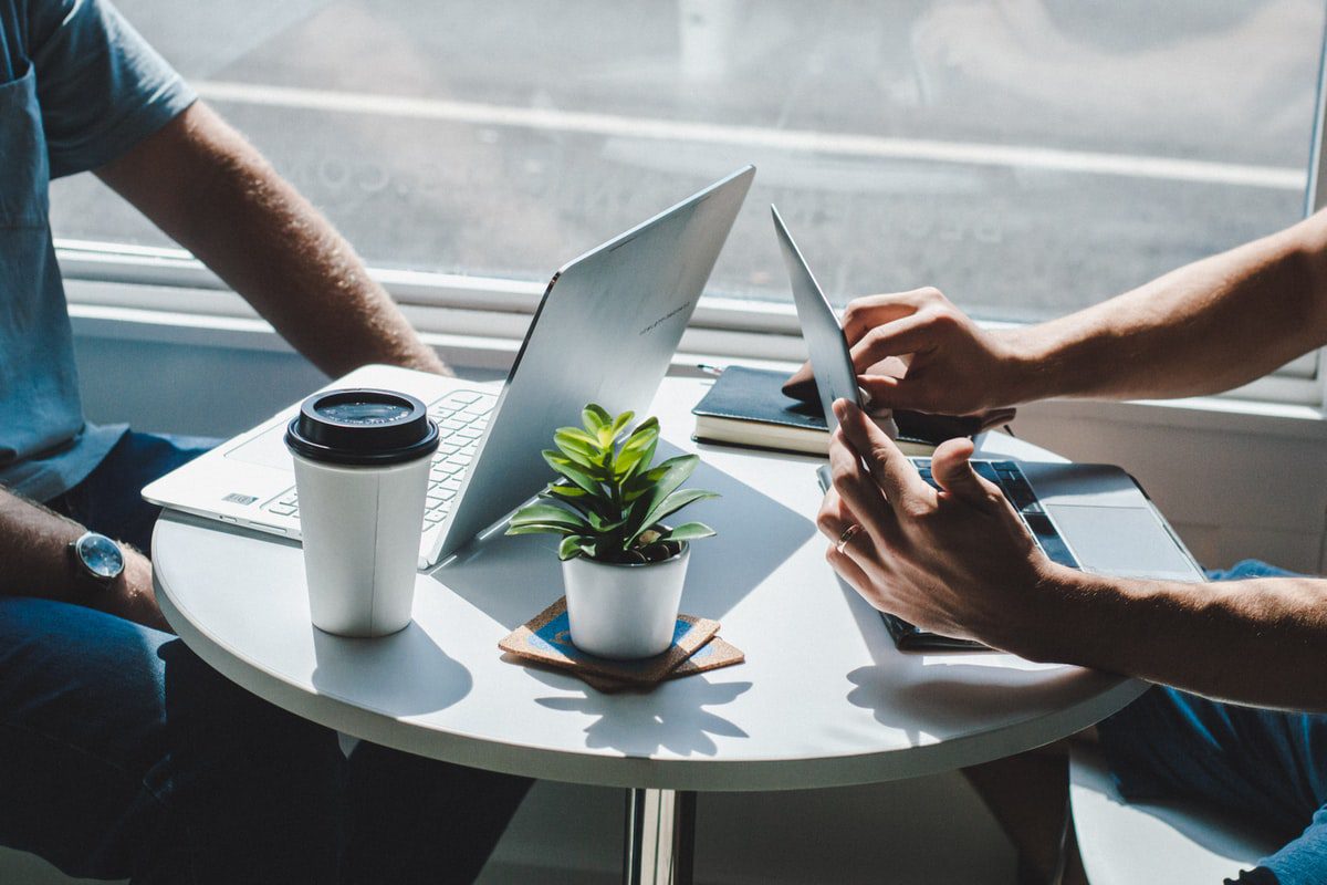 Two people preparing for an interview at a coffee shop