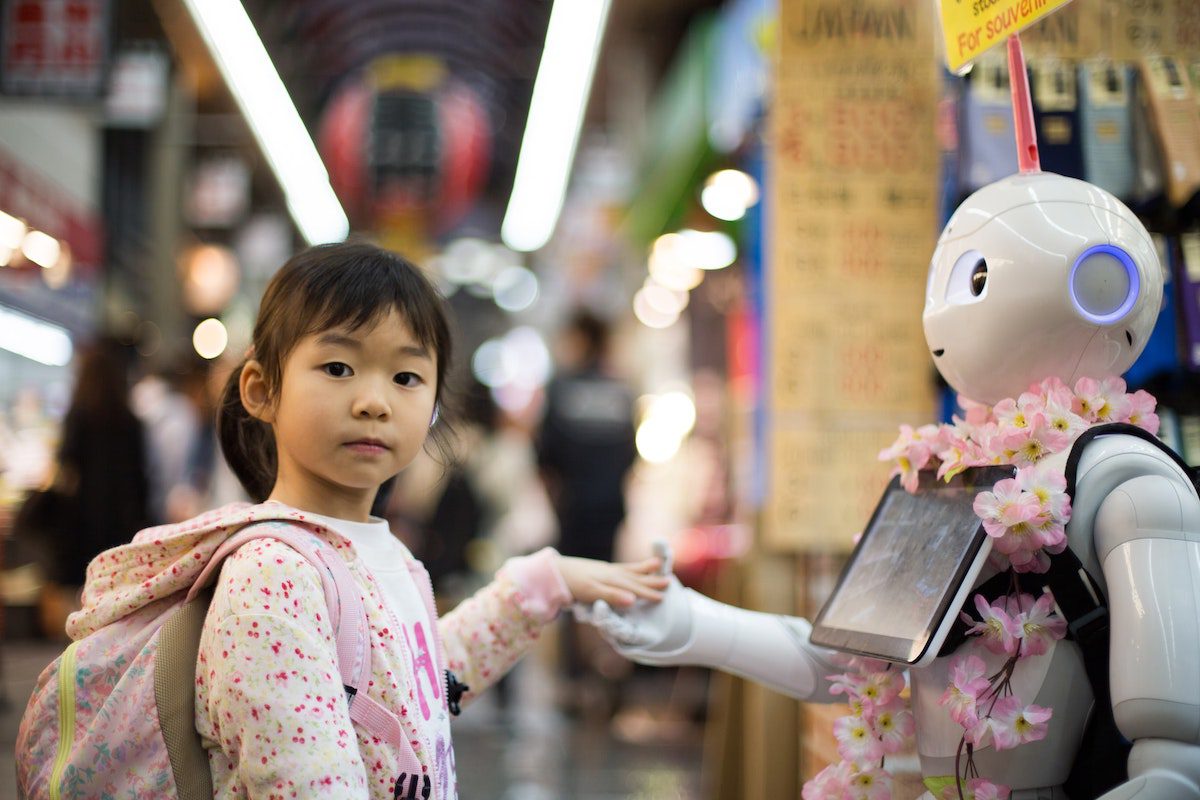 a robot holding hands with a little girl wearing a backpack. Jobs That Use Artificial Intelligence