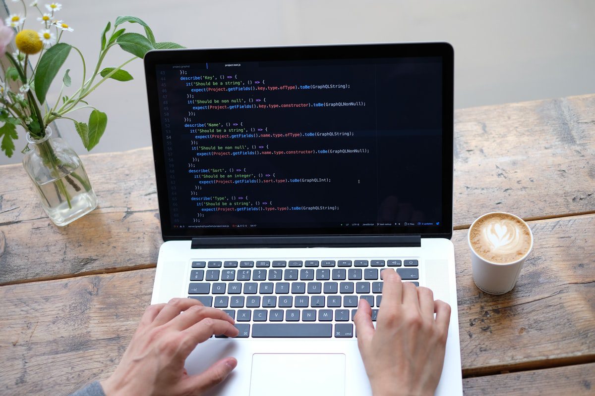 A man working on a computer program on a laptop.