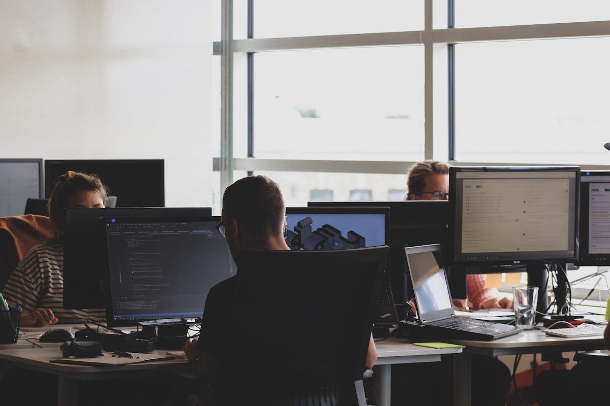 People in an office working on their computers.