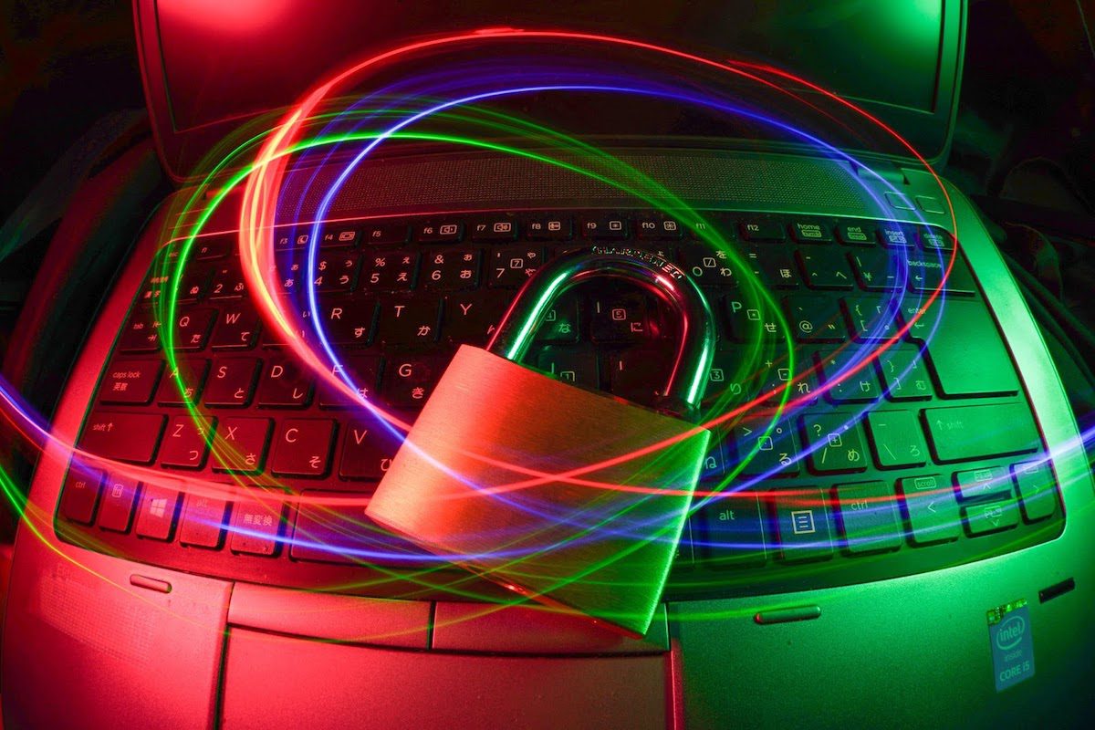 A lock hovering over a laptop keyboard.