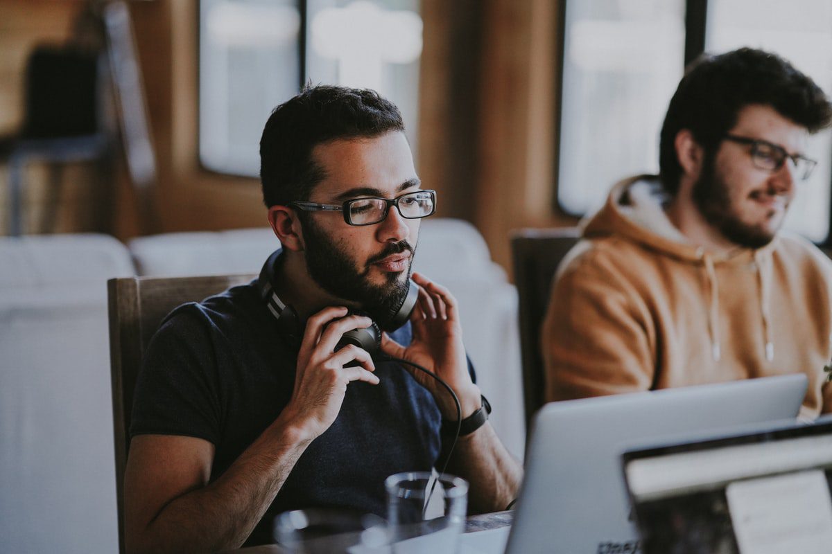 Two men working in a shared workspace
