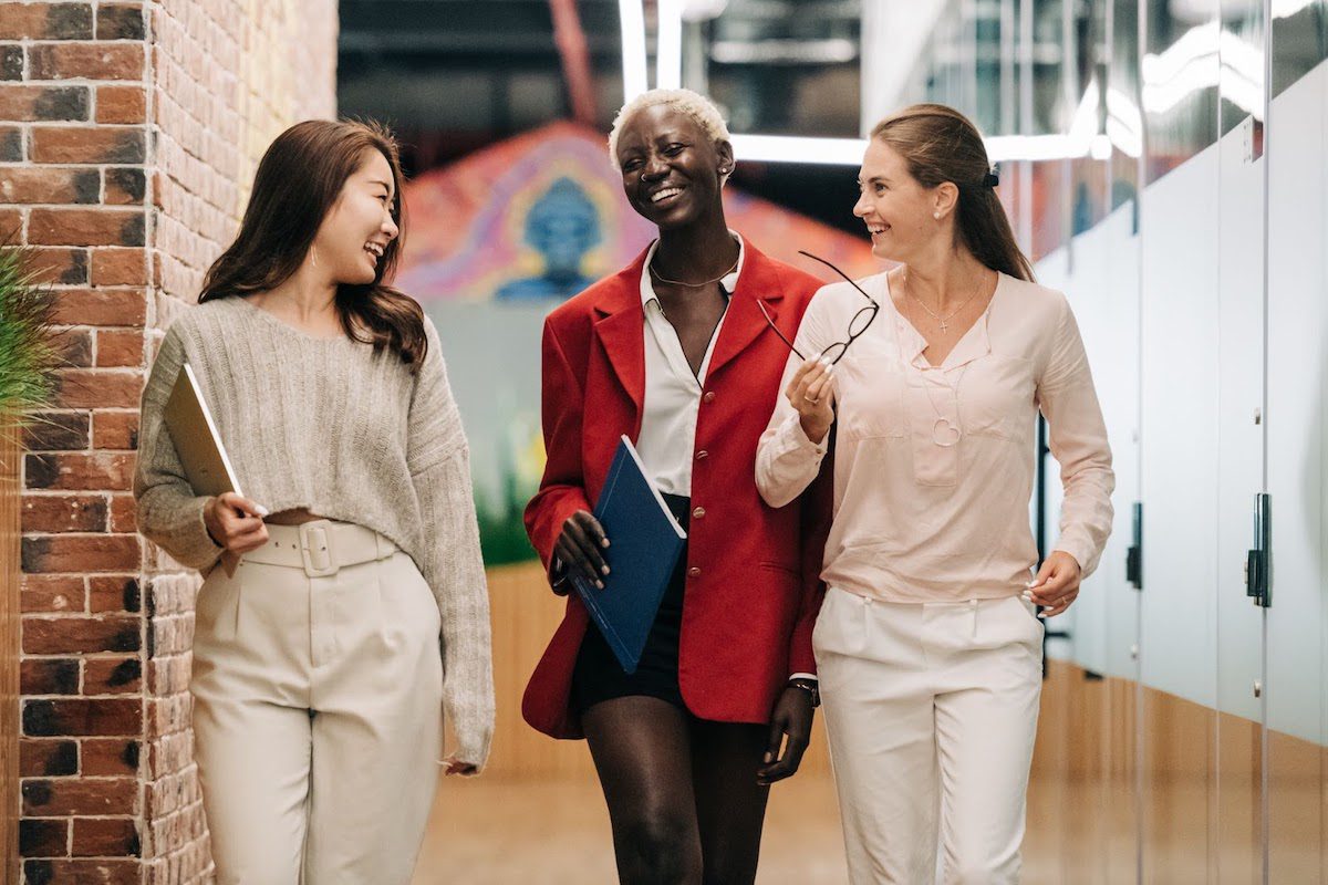 Three professional women walking together chatting and smiling Biggest Companies In Phoenix