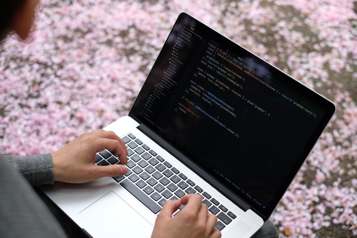 A programmer working on a laptop C IDE