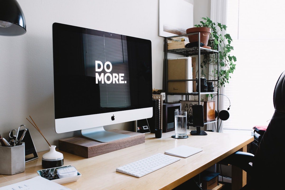 a silver iMac screen displaying the words “do more” Types of Web Development Jobs