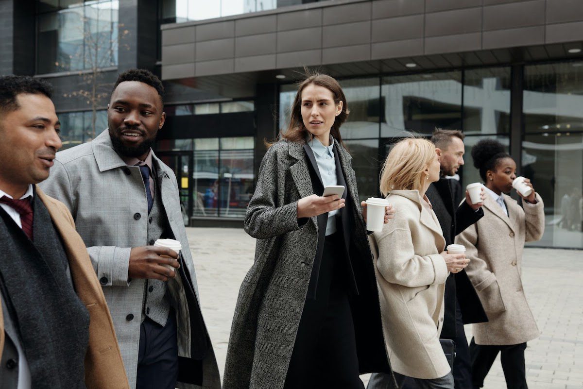 Facebook employees walking together on a coffee break. Facebook Benefits for Employees