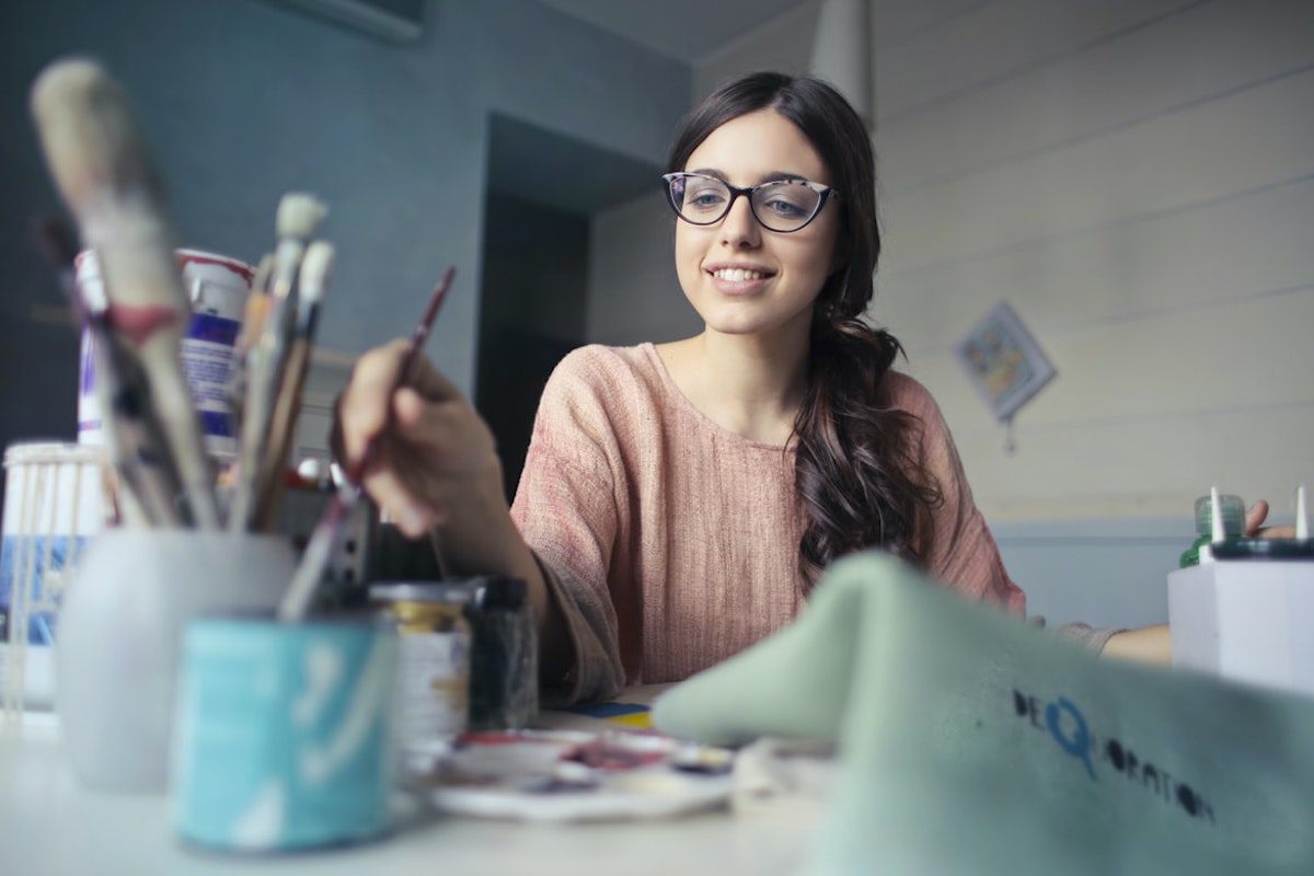 A painter picking a painting brush Jobs That Use Creativity