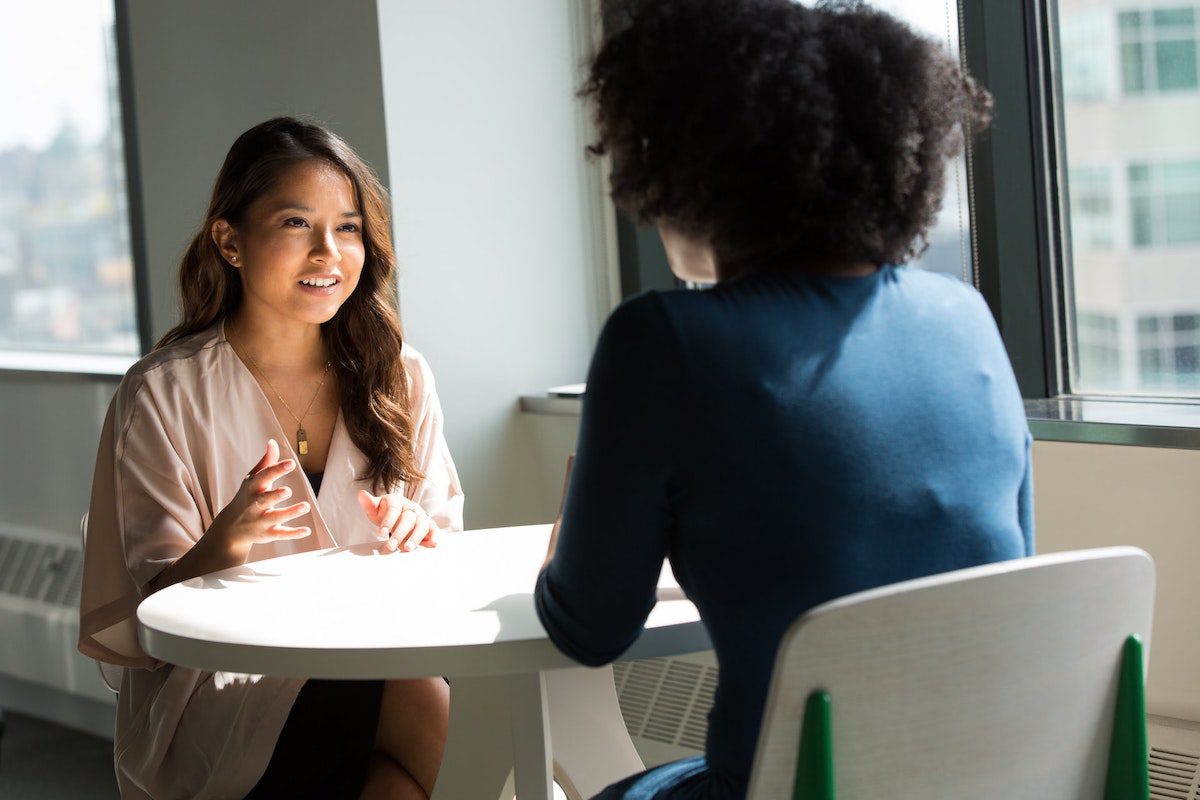 A recruiter and an intern applicant talking about her qualifications. How To Get An Internship At Capgemini