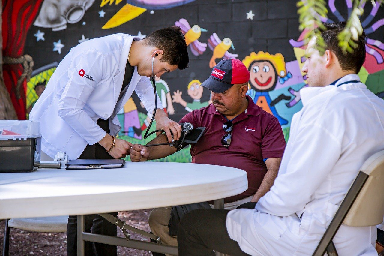 a doctor taking a patient’s blood pressure 