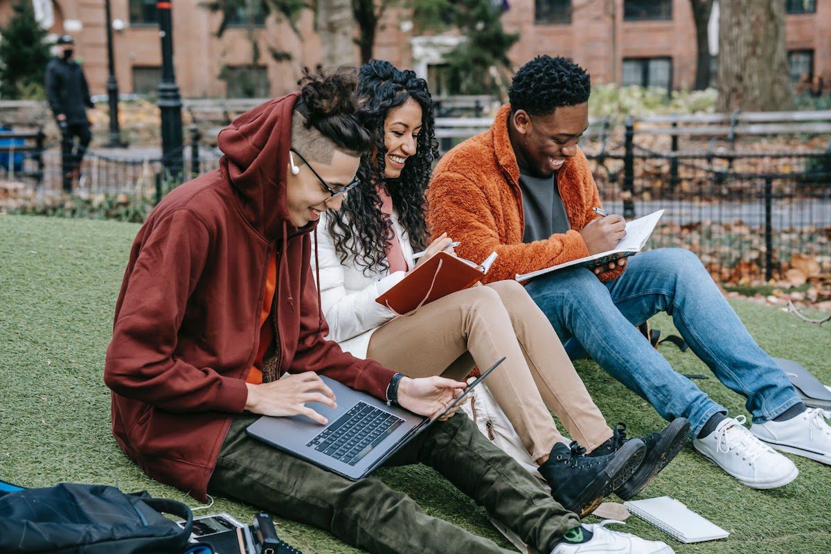 Three students studying together on a college campus.