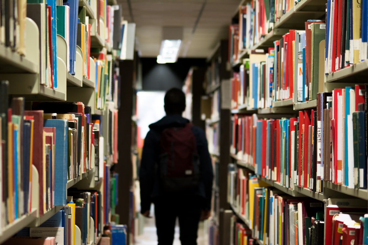 A student walks through a library.