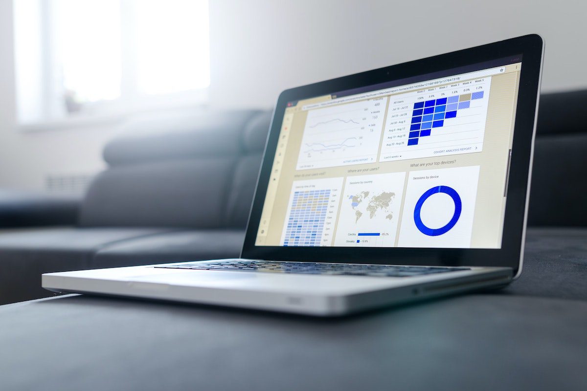 A laptop with data visualization following the completion of an analytics process. How Data Analytics Helps Business