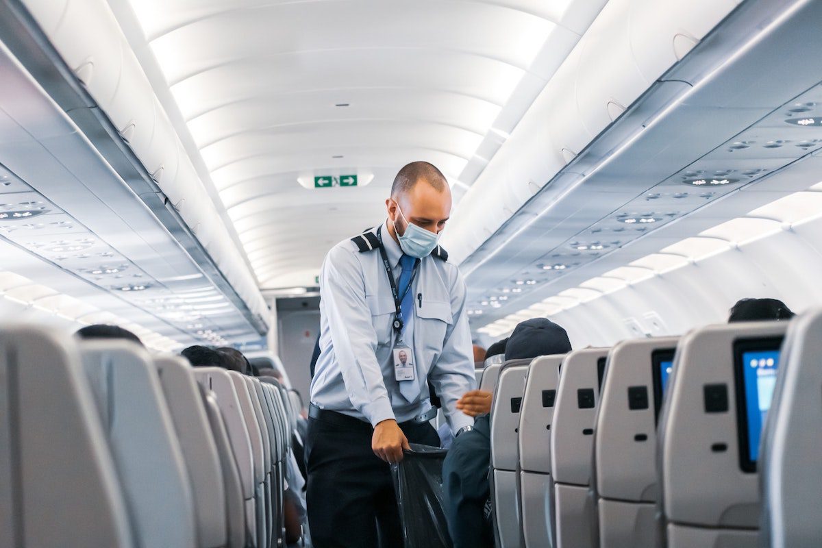 Flight attendant serving customers on a plane. Jobs That Require International Travel