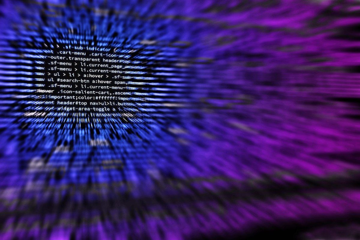 A blurred out and colorful image of lines of code on a computer screen. 