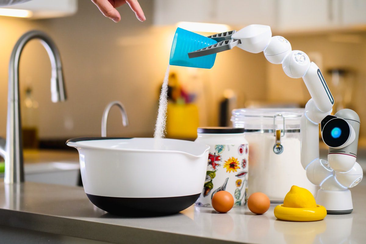 Robotic arm pouring ingredients into a bowl. Who Uses Go?